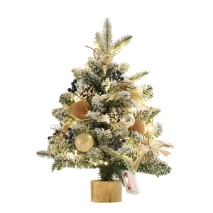 Mini snowy Christmas tree with LED lights, golden baubles, and wooden base decoration