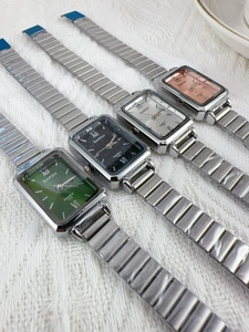 Detailed view of four BARSH rectangular quartz watches in green, black, silver, and pink dial