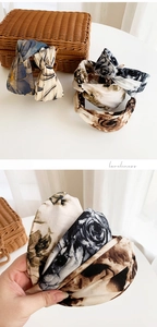 Detail view of colorful printed tie-dye wide headbands showing premium fabric texture