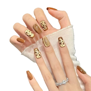 Short square press-on nails with caramel cat-eye effect and leopard print design