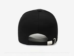 Adjustable back strap of the black baseball cap with silver metal buckle detail