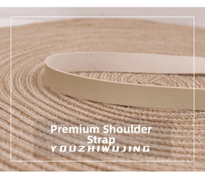 Detailed close-up of premium light beige leather strap with fine texture on woven mat