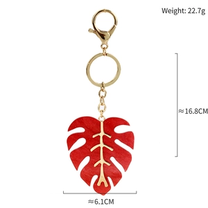 Detail view of red monstera leaf keychain with gold veins and 16.8cm total length
