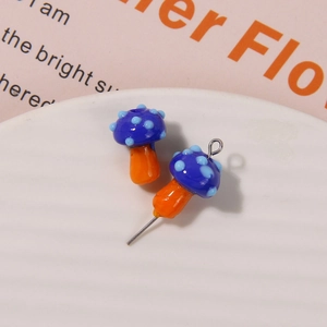Macro detail of blue and orange glass mushroom beads for DIY handmade jewelry crafting