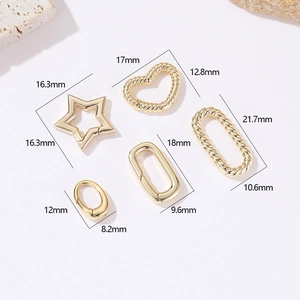 Detailed view of various gold-plated spring clasps in star, heart, and oval shapes for DIY