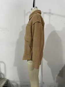Detail view of brown faux fur jacket showing large flap pockets and thick woolly texture