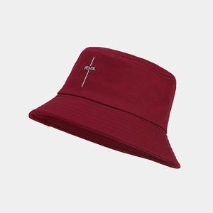 Detail of burgundy canvas bucket hat featuring peace embroidery and reinforced brim stitching