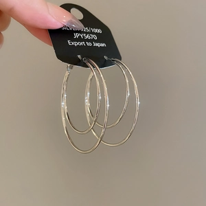 Close-up of minimalist S925 sterling silver double-layer round hoop earrings with tag