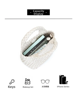Detail view of woven leather handbag interior showing storage for phone and accessories