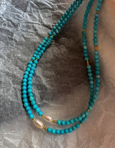 Detail of 18K gold-plated necklace with turquoise beads and baroque pearls
