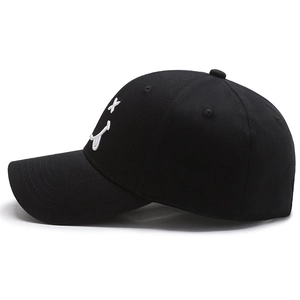 Classic black cotton baseball cap with white embroidered smiley face on plain background