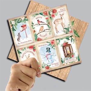 Close-up of vintage Christmas scrapbooking paper with reindeer and snowman illustrations