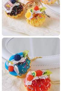 Macro detail of artificial fruit donuts with realistic strawberries and golden keychains