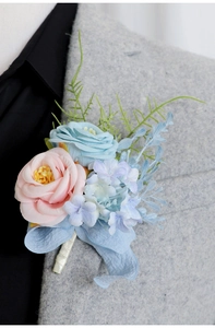 Close-up of elegant pink rose boutonniere pinned on a gray suit lapel for weddings