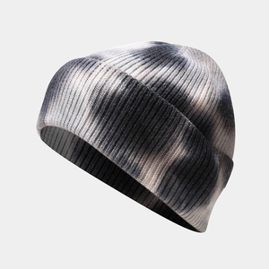 Close-up of tie-dye knit beanie with detailed black and white vertical rib texture