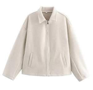 Detail view of the beige zip-up jacket collar with size label and metal zipper
