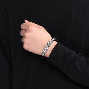 Detail shot of a men's silver stainless steel bike chain bracelet on a wrist