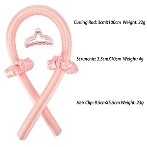 Pink heatless hair curler set with satin roller, two scrunchies and a clear claw clip