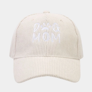 Detailed view of DOG MOM embroidery on beige corduroy texture of the baseball cap