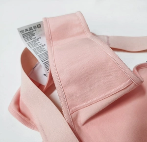 Close-up of pink cotton panties detail showing stitching quality and laundry care label