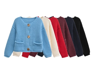 Detail of multi-color thick knit cardigans with vintage buttons and dual pockets