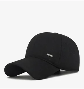 Close-up of black winter baseball cap showing thick fabric texture and metal logo