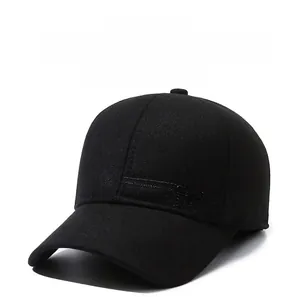 Detail view of black winter baseball cap featuring warm ear flaps and SPORT metal logo