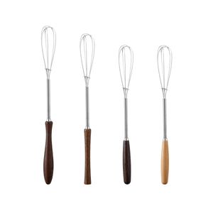 Set of 4 stainless steel egg whisks with different ergonomic natural wooden handles