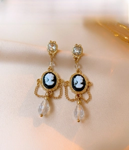 Detail of vintage French style portrait relief earrings with crystal teardrop charms