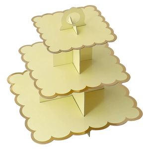 Three-tier square cardboard cupcake stand in soft yellow with gold foil scalloped edges