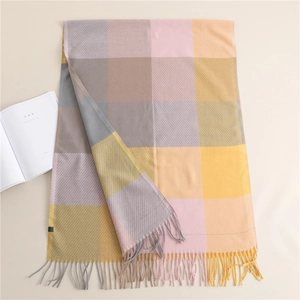 Close-up of thick plaid scarf featuring soft cashmere-like texture and long tassels