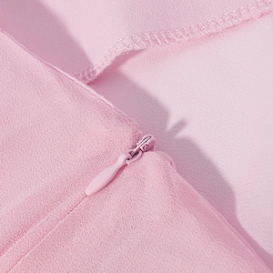 Detail of pink chiffon skirt with invisible zipper and premium fabric texture