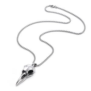 Macro view of a silver titanium steel raven skull pendant necklace with intricate carvings