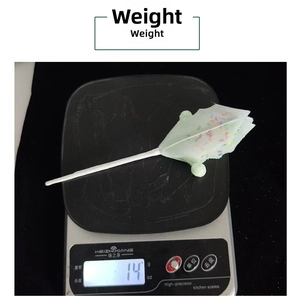 Weight measurement of a macaron Christmas flower prop on a digital scale showing 14g