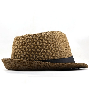 Detailed close-up of textured straw fedora weave with a decorative black ribbon band