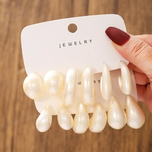 Set of 6 pairs of white pearlescent geometric earrings in various shapes on card