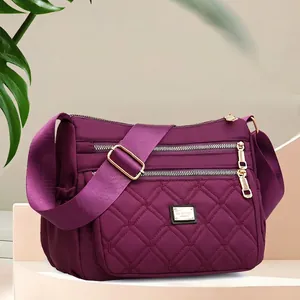 Quilted purple crossbody bag with large capacity and multi-zipper compartments