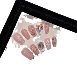 Long trapezoid press-on nails in nude pink glitter with white 3D butterfly and rhinestones