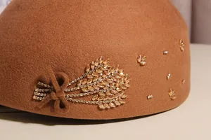 Detailed macro view of crystal wheat ear rhinestones on a brown wool beret hat