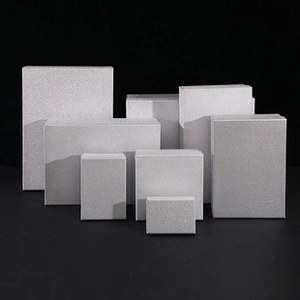 Collection of silver gift boxes with frosted glitter texture in various sizes on black backdrop