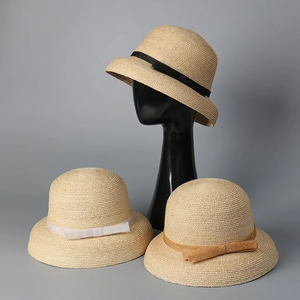 Detailed texture of high-quality raffia straw hats with elegant ribbon and bow accents