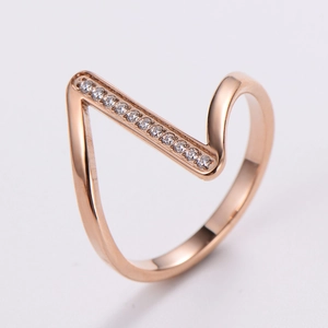 Detail of rose gold V-shaped ring with pavé sparkling cubic zirconia crystals