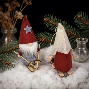 Charming set of two plush Christmas skiing gnomes with tall hats and wooden ski accessories