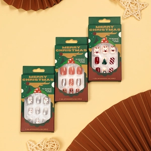 Christmas press-on nails with snowman and elk designs in a dark green holiday gift box