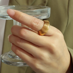 Modern layered geometric ring in 18K gold finish worn on finger for high-end fashion style