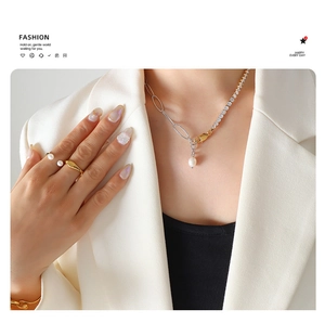 Detailed close-up of mixed chain necklace with zircon and freshwater pearl pendant set