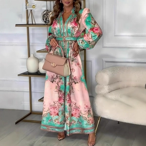 Detail of pink and teal floral maxi dress featuring elegant long sleeves and smooth texture
