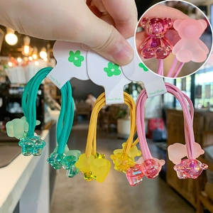 Detail view of gummy bear hair ties in mint green, warm orange, and cherry blossom pink colors