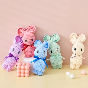 Close-up of rabbit-shaped coral fleece towels in pastel colors with Just For You ribbons