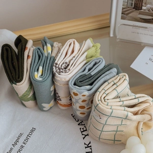 Detail view of 6-pair cotton socks set featuring floral and plaid patterns in earthy tones